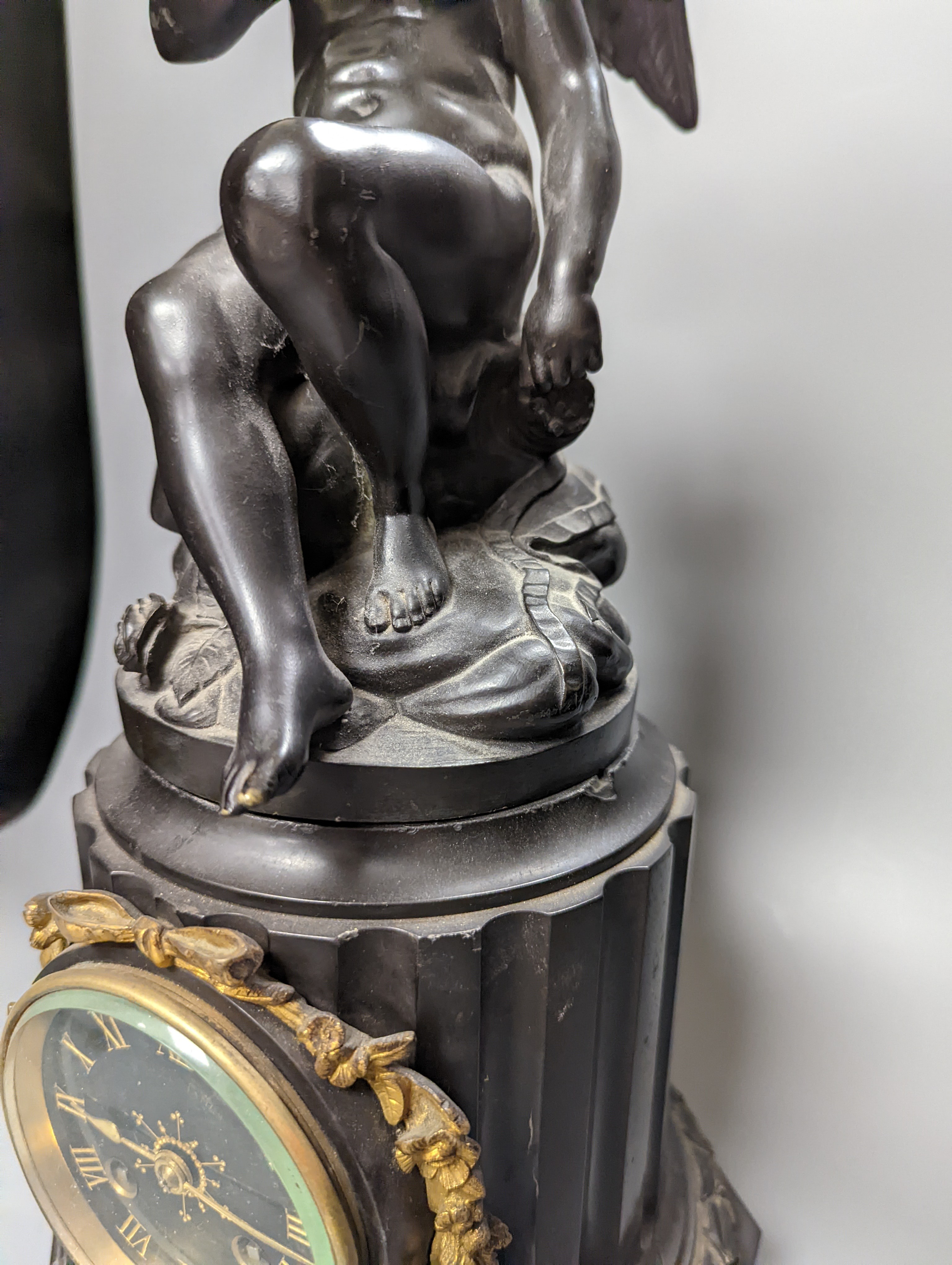 A Late 19th century French bronze and black slate mantel clock, with cherub surmount, drum movement, height 46cm